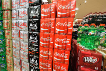 Sodas and energy drinks are stacked and line the shelves of a grocery store. Seth Perlman/AP