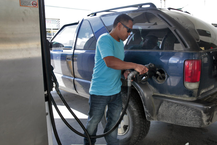 Richard Carrillo, of Juneau, gases up his suburban on July 7, 2016, in Juneau, Alaska. State economists said low energy prices caused a slower growth of inflation in Alaska last year. (Photo by Rashah McChesney/KTOO)