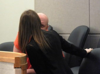 A defendant confers with his court-appointed defense attorney during an arraignment at the Dimond Courthouse in Juneau.