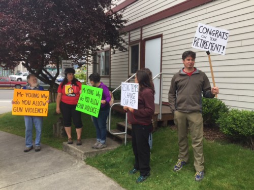 Protesters hold signs critical of Rep. Don Young while he spoke in Sitka. (Photo by Emily Kwong/KCAW) 