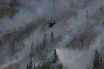 A helicopter dumps water to fight the McHugh fire on July 20, 2016. (Photo by Wesley Early/Alaska Public Media)