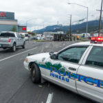 A Juneau Police Department cruiser closes the inbound lanes of Egan Drive after a truck rollover on July 25th, 2016. (Photo by Mikko Wilson / KTOO)