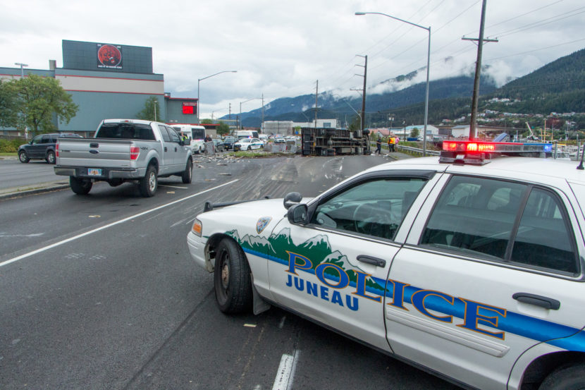 A Juneau Police Department cruiser closes the inbound lanes of Egan Drive after a truck rollover on July 25th, 2016. (Photo by Mikko Wilson / KTOO)