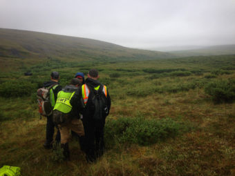 Members of the final day’s search crew for missing hiker Joseph Balderas review a map of the area in Nome in July 2016. (Photo: by Emily Russell/KNOM)