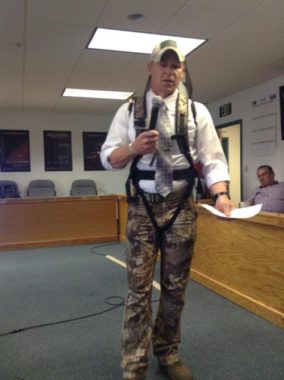 Larry Bartlett of Fairbanks, wearing a dress shirt and hunting gear, makes his case for passing the special action to allow sport hunting in Unit 23. (Photo by Tyler Stup/KNOM)