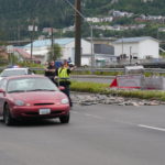 Juneau Police direct traffic around an overturned truck on Egan Drive on Monday, July 25, 2016. (Photo by Lakeidra Chavis / KTOO)