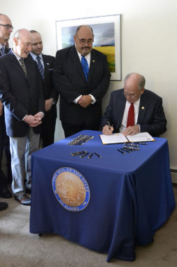 Gov. Bill Walker signs Senate Bill 91, a criminal justice reform bill, on July 11, 2016, at Haven House transitional housing in Juneau. (Photo courtesy Alaska Governor's Office)