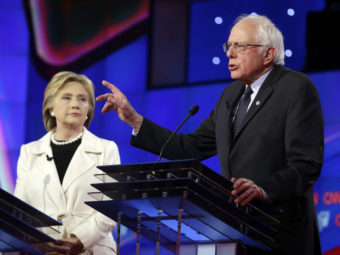 Sen. Bernie Sanders, I-V.t, right, speaks as Hillary Clinton looks on during an April Democratic debate in New York. (Photo by Seth Wenig/AP)