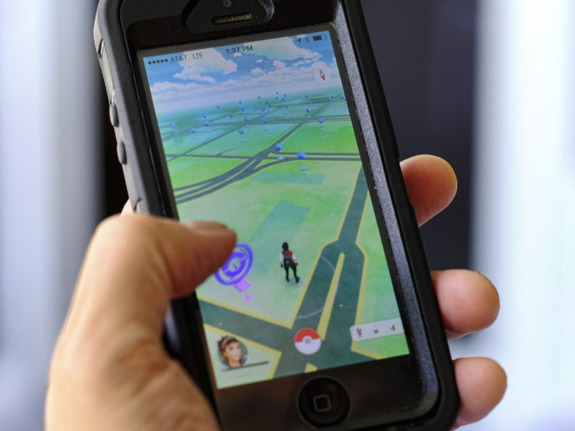 The Pokémon Go mobile game is the top-grossing app for Android and iPhone. Today, the U.S. Holocaust Museum and Arlington National Cemetery asked people to refrain from using the game while visiting the somber sites. (Photo by Richard Vogel/AP)
