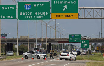 Baton Rouge police block Airline Highway after police were shot in Baton Rouge, La., Sunday, July 17, 2016. Authorities in Louisiana say several law enforcement officers are dead, and several injured in Baton Rouge after on-duty law enforcement officers were shot on Sunday morning. Max Becherer/AP