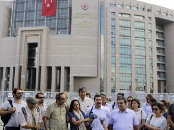 Journalists gather outside a court building to support journalist Bulent Mumay, who was detained Tuesday in connection with the investigation of the attempted coup in Turkey. (Photo by Petros Karadjias/AP)