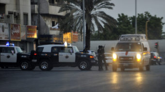 Saudi policemen stand guard at the site where a suicide bomber blew himself Monday, near the U.S. consulate in the Red Sea city of Jeddah.