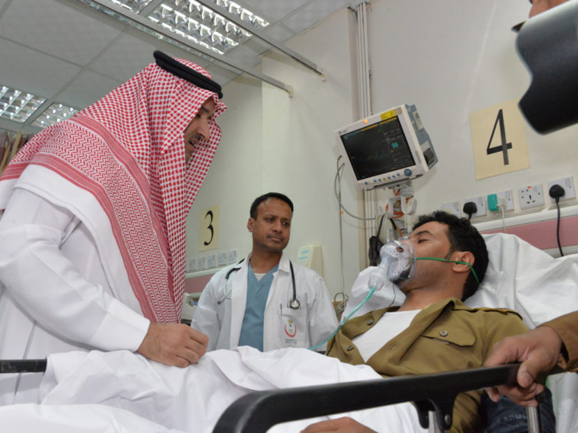 Saudi Prince Faisal bin Salman bin Abdulaziz (left) visits an injured policeman at a local hospital following a suicide attack near the security headquarters of the Prophet's Mosque in Medina on July 4. (STR/AFP/Getty Images)