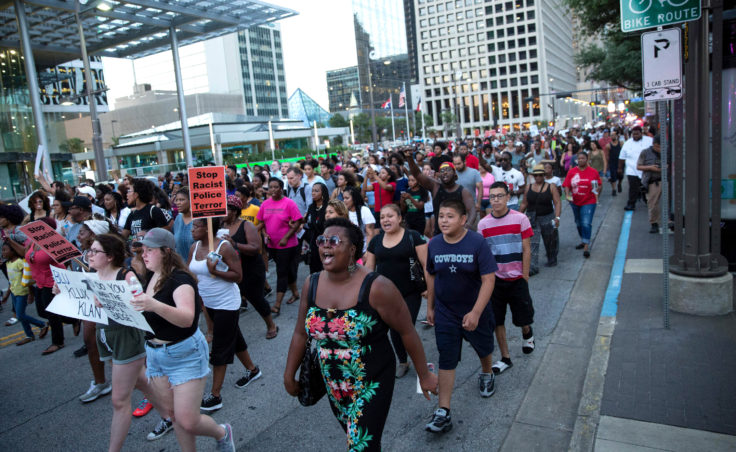 People rally in Dallas on Thursday to protest the deaths of Alton Sterling and Philando Castile. (Laura Buckman/AFP/Getty Images)