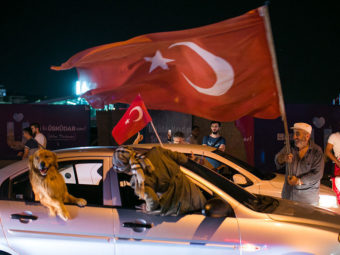 i People drive next to a Turkish man waving a flag in Uskudar district in Istanbul on July 16, 2016 during a demonstration in support to Turkish president. Gurcan Ozturk/AFP/Getty Images