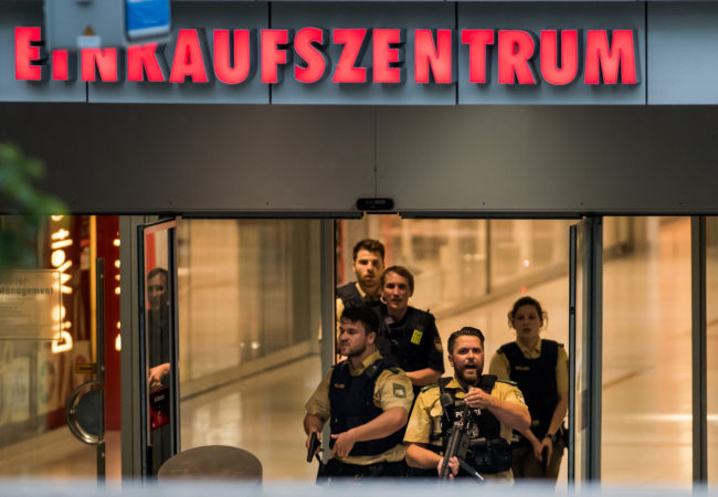 Police officers respond to a shooting at the Olympia Einkaufzentrum shopping center on Friday in Munich, Germany. (Joerg Koch/Getty Images)