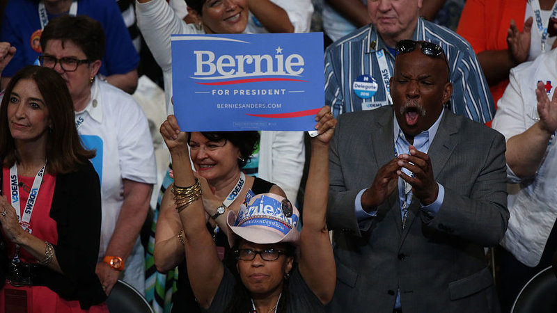 A delegate holds a campaign sign in support of Sen. Bernie Sanders, I-Vt., during the Democratic National Convention in Philadelphia. Bloomberg/Bloomberg via Getty Images
