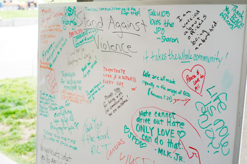 People shared their thoughts on white boards in Marine Park at a community gathering hosted by the Juneau Police Department, July 20, 2016. (Photo by Annie Bartholomew/KTOO)