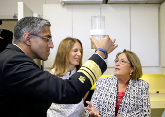 Surgeon General Vivek Murthy looks at a sample of mosquitoes in Orlando, Fla., on Monday. With him is Department of Health and Human Services Secretary Sylvia Burwell and Orange County Mayor Teresa Jacobs.