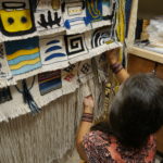 Clarissa Rizal unpins a block to show the details in the weave. (Photo by Tripp J Crouse/KTOO)