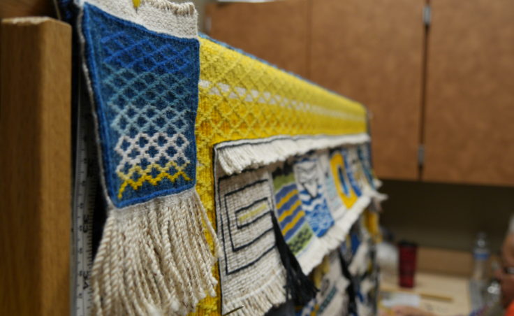 Teahonna James square is tacked to the loom at the Sealaska Heritage Institute, Juneau. James' design inspired the pattern and colors of the Weavers Across Waters Chilkat/Ravenstail community robe. (Photo by Tripp J Crouse/KTOO)