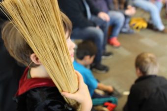 A young Harry Potter fan watches an improvised game of Quidditch at Sitka Public LIbrary. (Katherine Rose, KCAW)