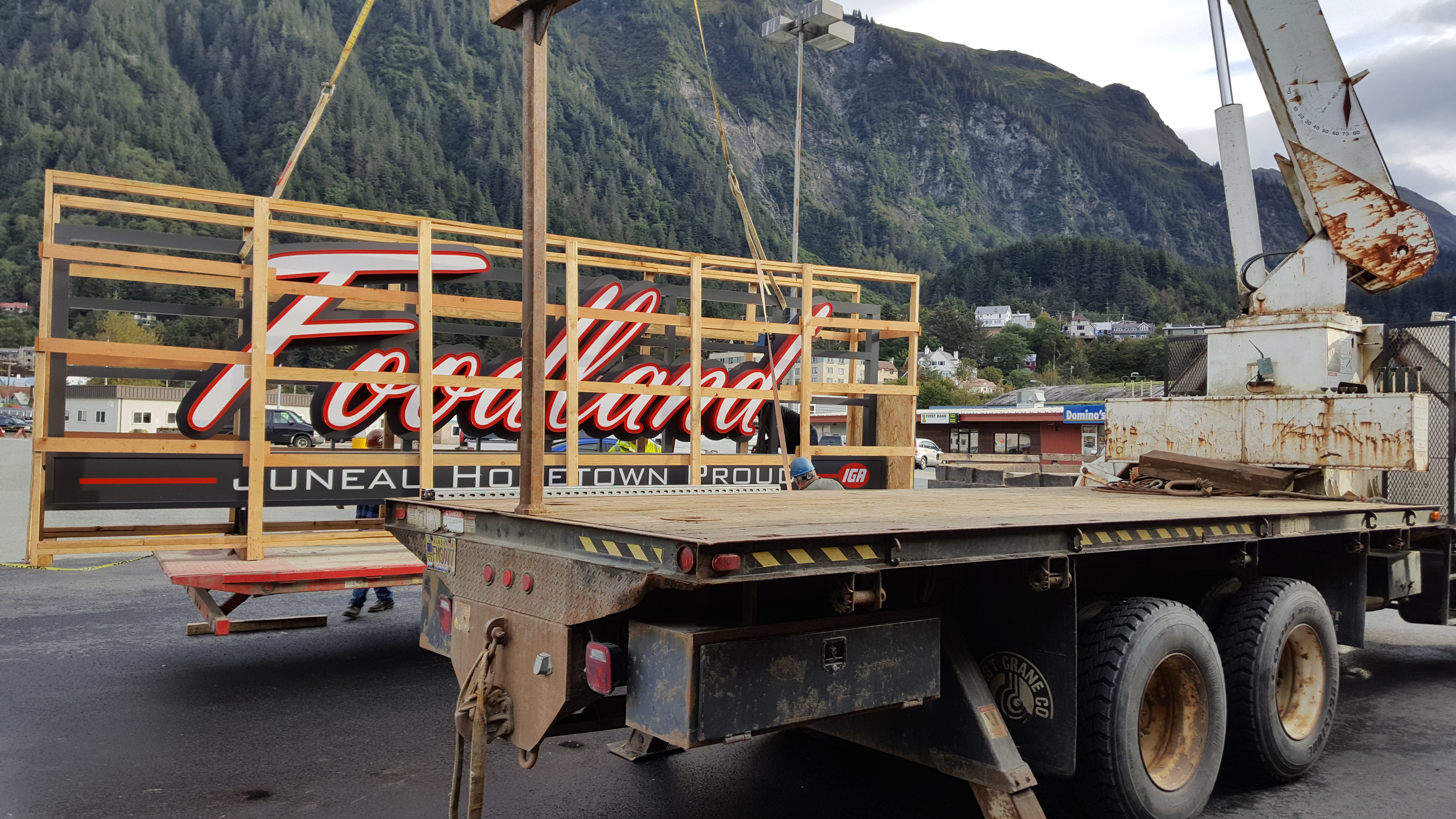 Workers from North Pacific Erectors Inc. of Douglas install a new sign at Foodland IGA in downtown Juneau. Store director Rick Wilson said the installation should be completed Tuesday afternoon. (Photo by Tripp J Crouse/KTOO)