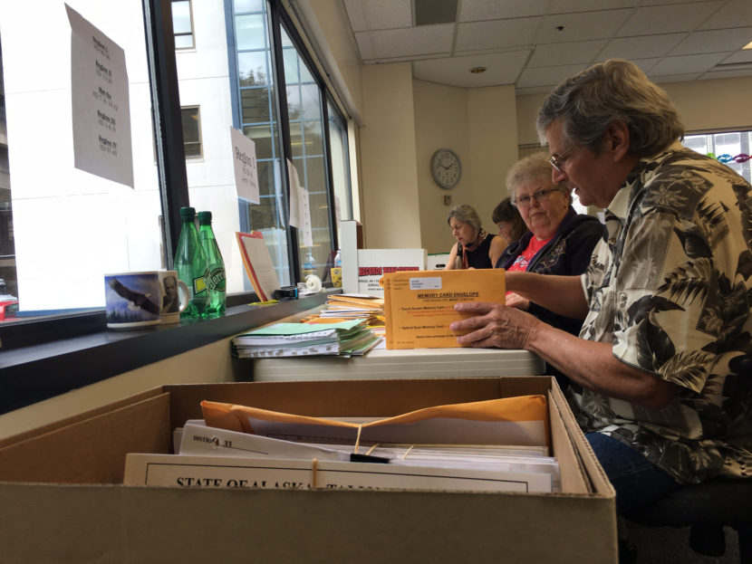 Election review board members sort through election materials at the Division of Elections office in Juneau, Aug. 30, 2016. (By Andrew Kitchenman/KTOO)