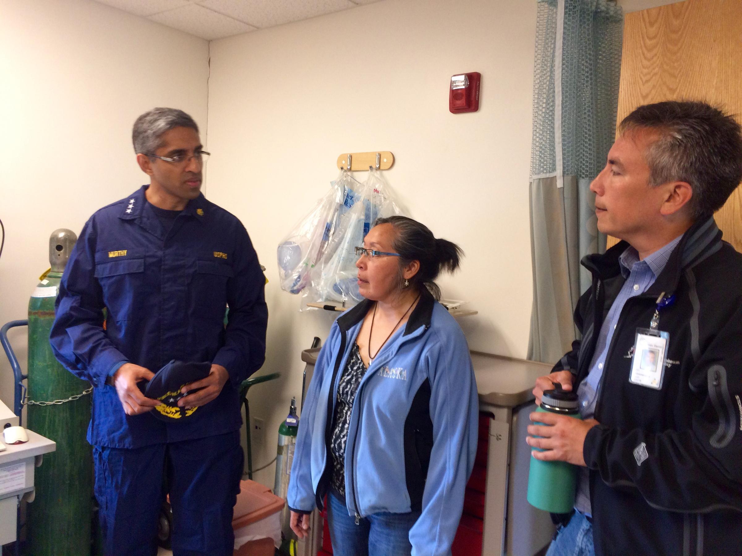 U.S. Surgeon General Dr. Vivek Murthy in the Napaskiak clinic with Community Health Practitioner Augusta Williams and YKHC CEO Dan Winkelman. (Anna Rose MacArthur, KYUK)