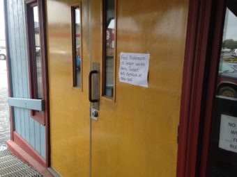 A sign posted on the door of the Aleknagik building in downtown Dillingham, where the ANL office is located. (Photo by KDLG)