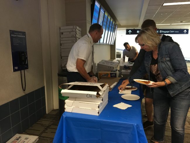 Delta passengers in Minneapolis get free pizza on Monday afternoon, Aug. 8, 2016. (Photo by Annie Feidt/Alaska’s Energy Desk)