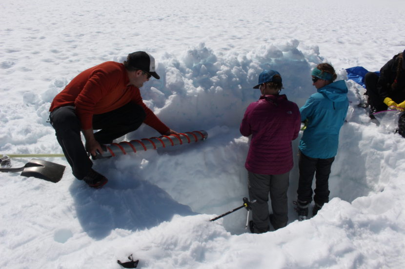 Shad O'Neel releases an ice core onto a work station. (Photo by Elizabeth Jenkins/KTOO)
