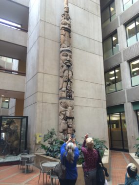 Seckel and Rudis talk about the Old Witch Totem in the State Office Building. (Photo by Scott Burton/KTOO).