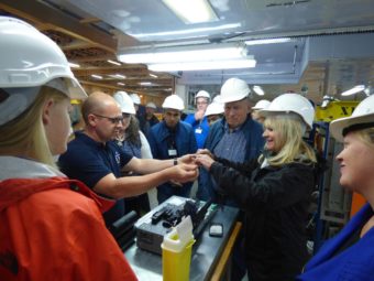 Governor Bill Walker and Donna Walker inspect a section of fiber optic cable aboard the vessel Ile de Sein. (Laura Kraegel, KUCB)
