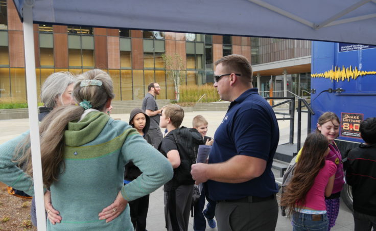 Chad Fullmer talks with attendees of the earthquake simulator on Wednesday, August 31, 2016. Fullmer is an emergency management specialist with the Alaska Division of Homeland Security and Emergency Management. (Photo by Tripp J Crouse/KTOO)