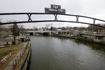 A sign over the Flint River in Flint, Mich. in January 2016. Carlos Osorio/AP