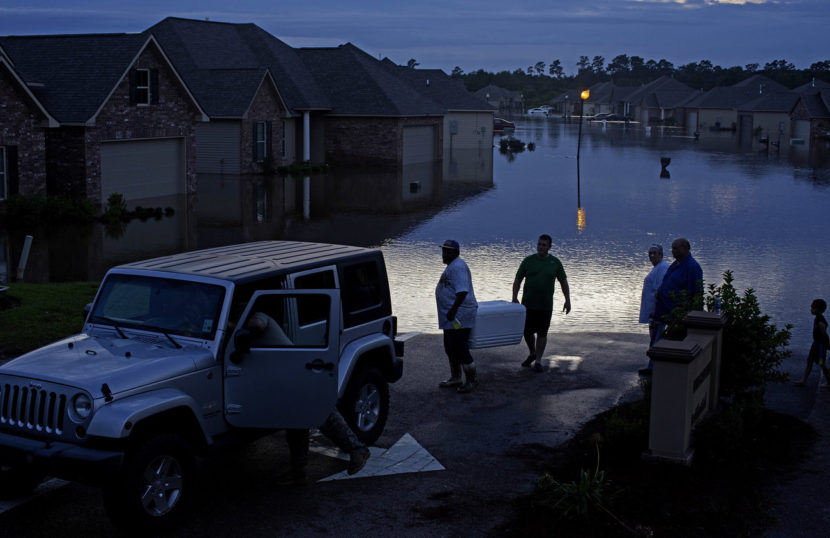 Residents evacuate with food in ice chests in Hammond, La., on Saturday. Max Becherer/AP