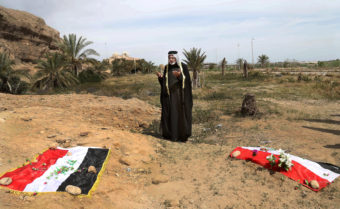 An Iraqi man prays in 2015 for his slain relative, at the site of a mass grave, believed to contain the bodies of Iraqi soldiers killed by Islamic State group militants when they overran Camp Speicher military base, in Tikrit, Iraq. Khalid Mohammed/AP