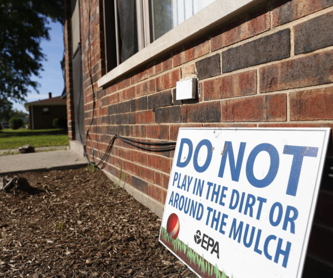 A sign from the Environmental Protection Agency posted in front of West Calumet Housing Complex houses in East Chicago, Ind. (Photo by Tae-Gyun Kim/Associated Press)