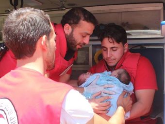 A Syrian Red Crescent team works to evacuate the conjoined twins to a hospital in Damascus on Friday. Courtesy of the Syrian American Medical Society