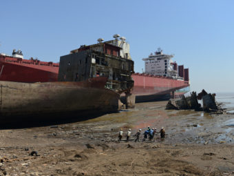 Indian shipbreakers work at the Sosiya-Alang Ship Recycling yard on March 4, 2013. Many ships are heading to scrap heaps, like this one, the world's largest, to help reduce the number competing for market share. SAM PANTHAKY/AFP/Getty Images