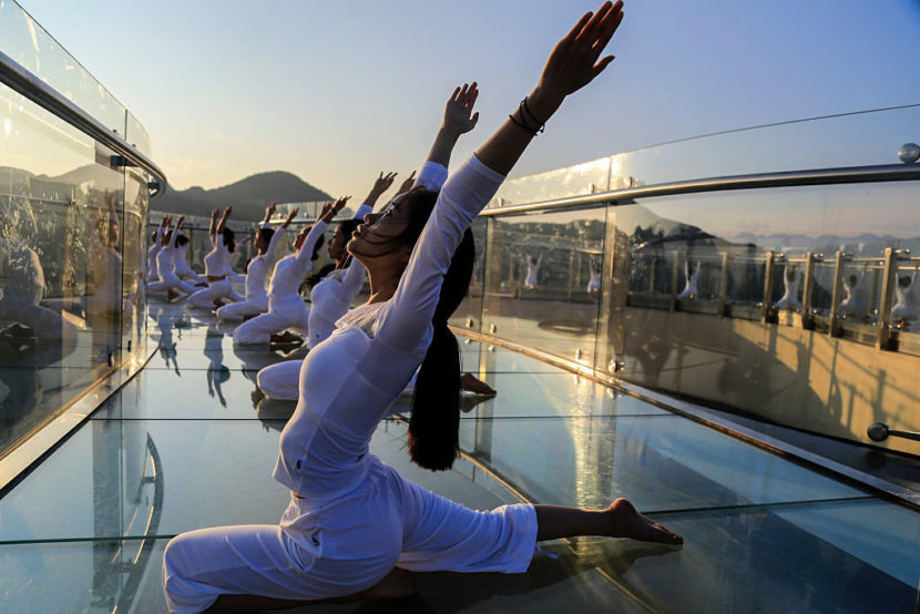 One example: Fifty women practice yoga on the skywalk at the Longgang National Geological Park in July in Chongqing, China. VCG/VCG via Getty Images