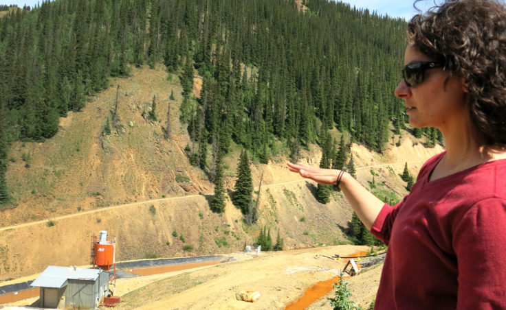 Joyel Dhieux, EPA on-scene coordinator, looks at an old water treatment that stopped operating near the base of the Gold King Mine in the early 2000s. The EPA built its own temporary plant in October 2015 after the Gold King Mine spill. (Grace Hood, Colorado Public Radio)