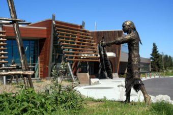 A “Łuq’a Nagh Ghilghuzht” sculpture by Joel Isaak depicts traditional Dena’ina life at fish camp outside the Kenaitze Indian Tribe’s new Dena’ina Wellness Center in Old Town Kenai.