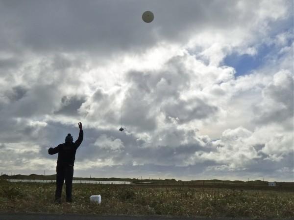 William Wells releases a weather balloon on Alaska's St. Paul Island. (John Ryan photo)