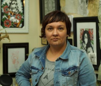 Holly Mititquq Nordlum at Above The Rest tattoo shop in Anchorage, where she’s working to meet the state’s official requirements to be eligible for a tattoo license.