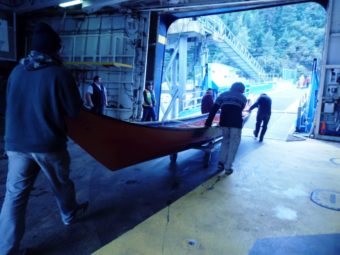 Price and volunteers rolled the canoes off of the ferry on trailers. (Photo by Abbey Collins/KHNS)
