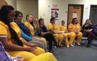 Women at Hiland Mountain Correctional Center listen to the songs they wrote together for their children. (Photo by Anne Hillman/Alaska Public Media)