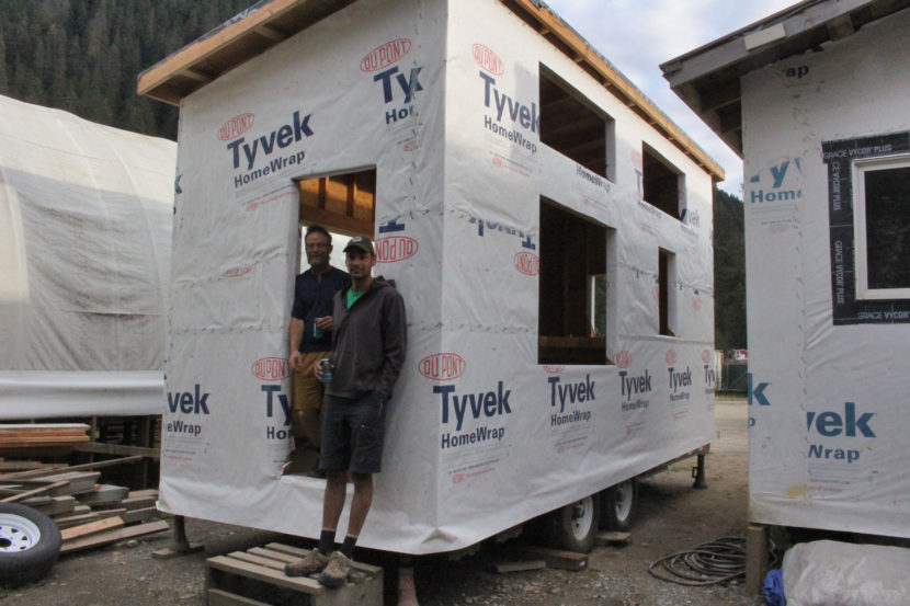 Jason Donig (right) and Jeff Martinson (left) stand in front of the tiny they're building. (Photo by Elizabeth Jenkins/KTOO)