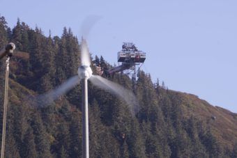 Wind spins a turbine at Coast Guard Station Juneau, Sept. 29, 2016. The Goldbelt Mount Roberts Tramway is visible between the blades. (Photo by Jeremy Hsieh/KTOO)
